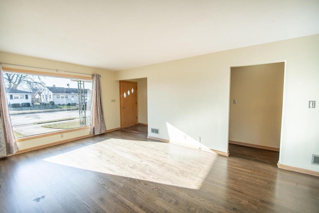 unfurnished room with wood-type flooring