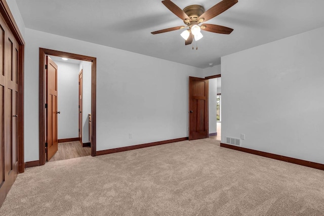 unfurnished bedroom with light carpet and ceiling fan