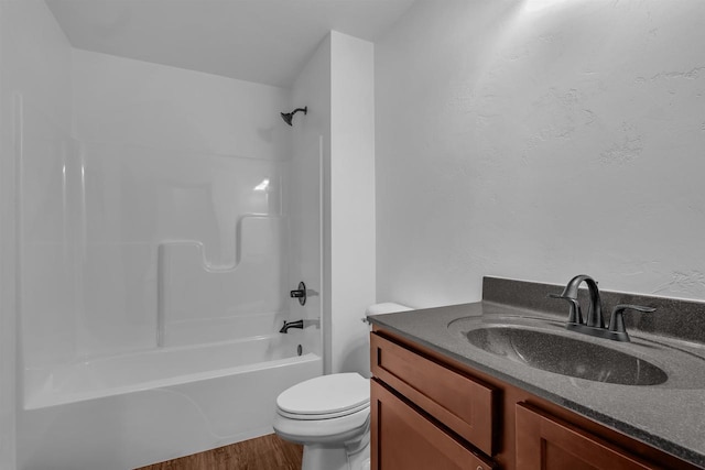 full bathroom with wood-type flooring, vanity, shower / bath combination, and toilet