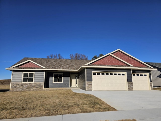 craftsman-style house with a garage and a front lawn