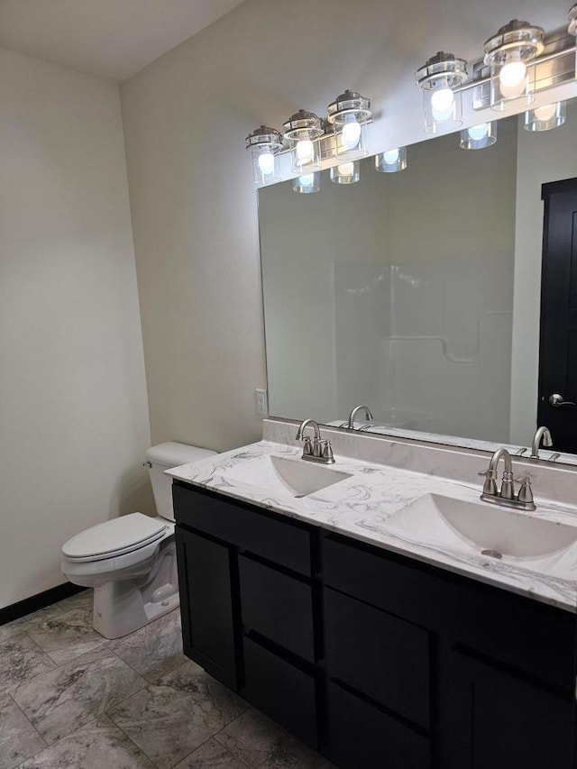 bathroom featuring vanity and toilet