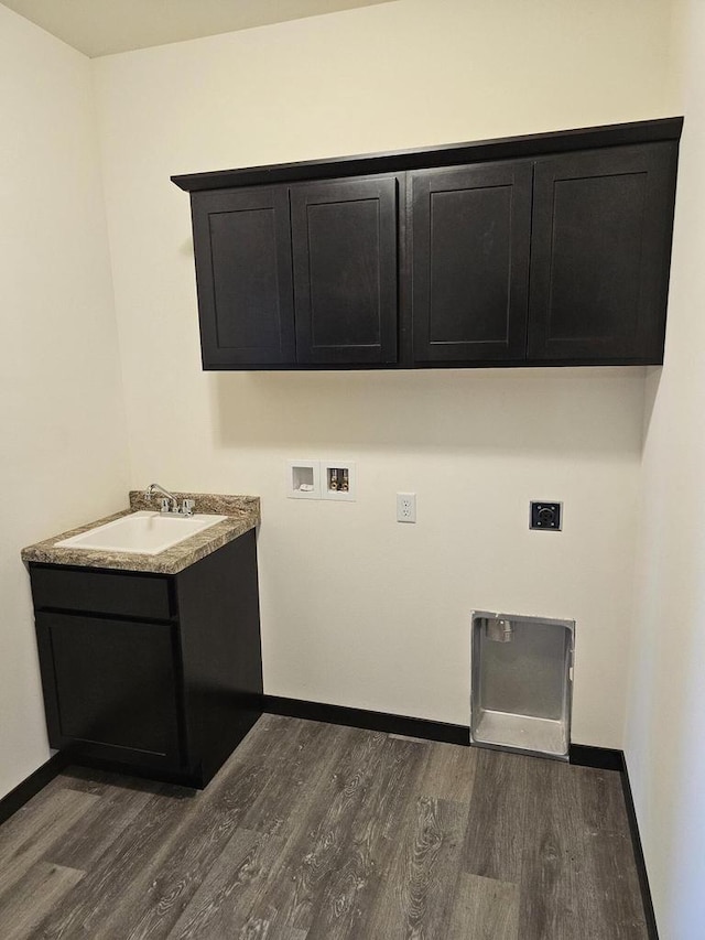 washroom featuring sink, cabinets, hookup for an electric dryer, dark hardwood / wood-style flooring, and hookup for a washing machine