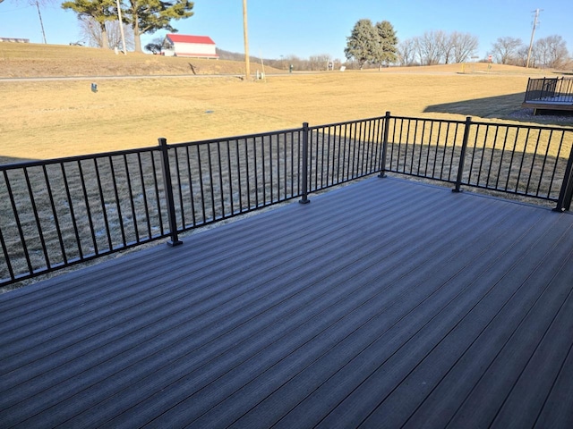 wooden deck with a rural view