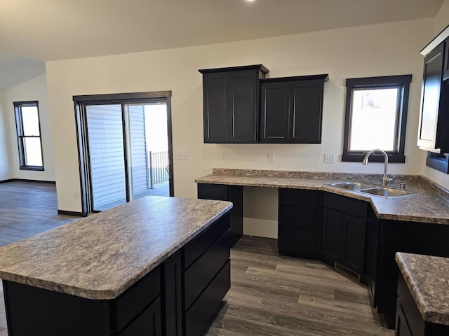 kitchen with a kitchen island, dark hardwood / wood-style flooring, and sink