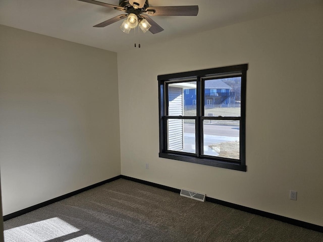 carpeted empty room featuring ceiling fan