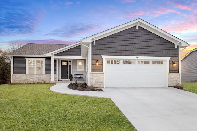 craftsman-style home with a yard and a garage