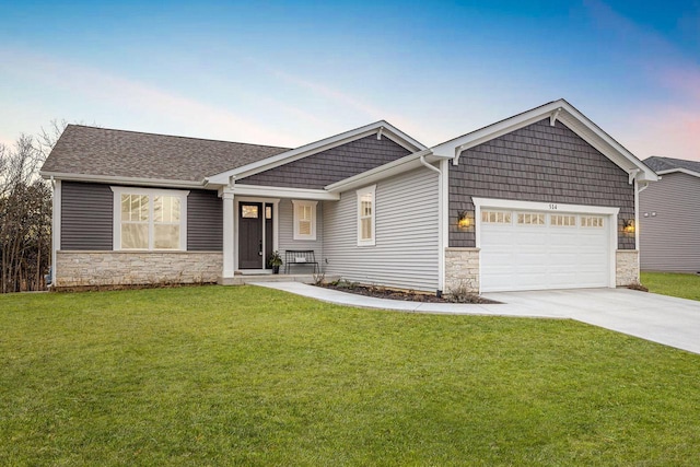 ranch-style house featuring a yard and a garage