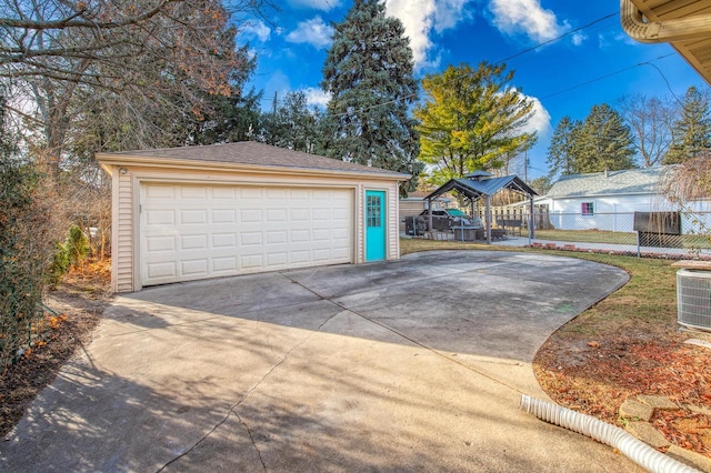 garage featuring a carport and cooling unit