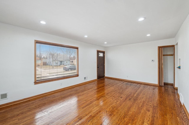 unfurnished room with hardwood / wood-style floors