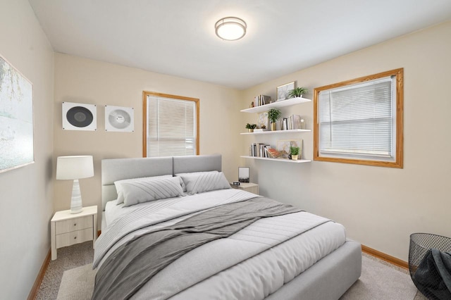 bedroom featuring light carpet and multiple windows