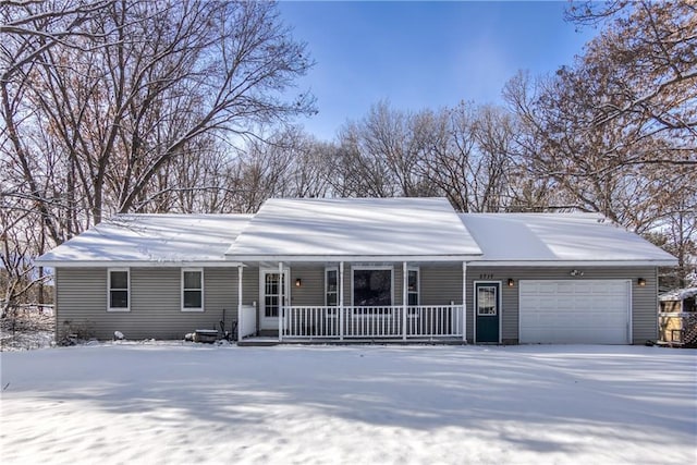 ranch-style home featuring covered porch and a garage