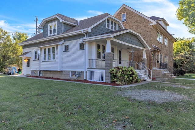 view of side of property with a porch and a yard