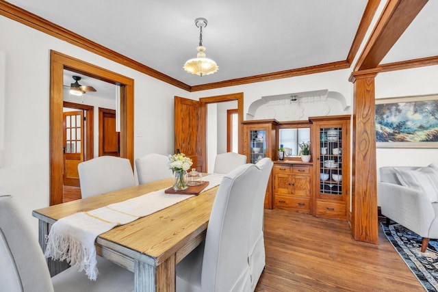 dining area with hardwood / wood-style flooring, ceiling fan, and crown molding