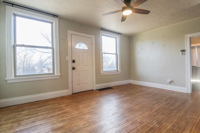 foyer entrance featuring wood-type flooring and ceiling fan