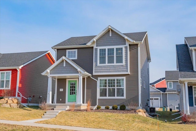 view of front of home with a front yard and a garage