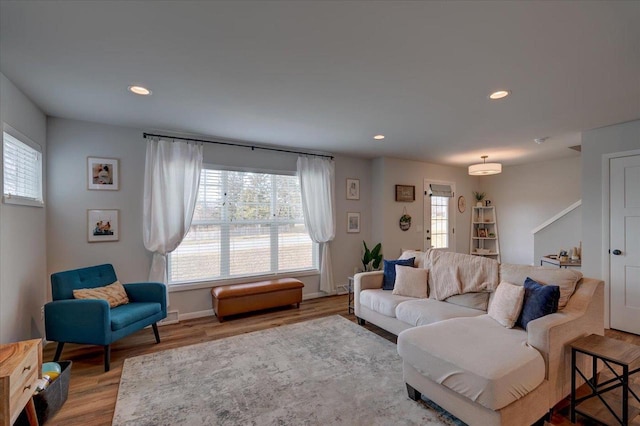 living room with hardwood / wood-style floors and a healthy amount of sunlight