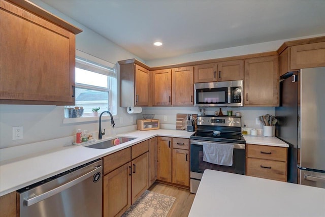 kitchen featuring light hardwood / wood-style floors, sink, and appliances with stainless steel finishes