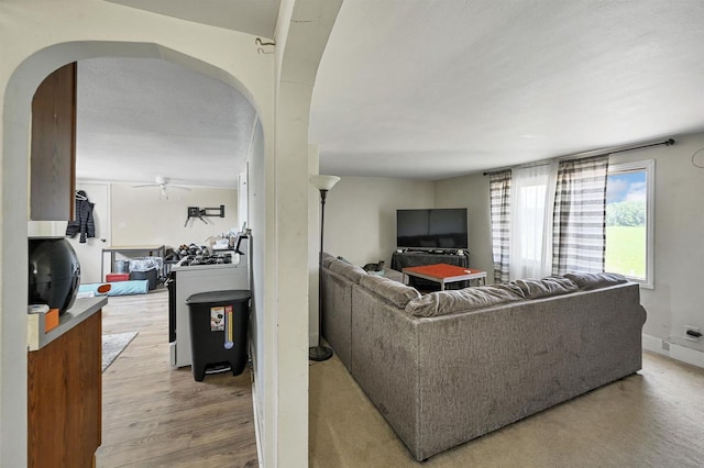 living room with hardwood / wood-style floors and ceiling fan