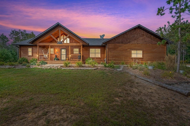 log home with a lawn and a porch