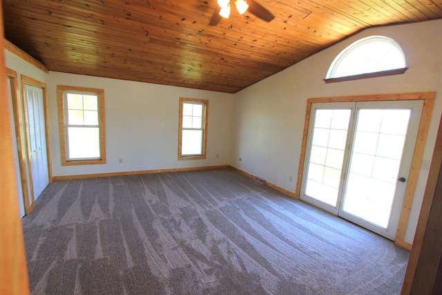 unfurnished room with dark colored carpet, plenty of natural light, wooden ceiling, and vaulted ceiling