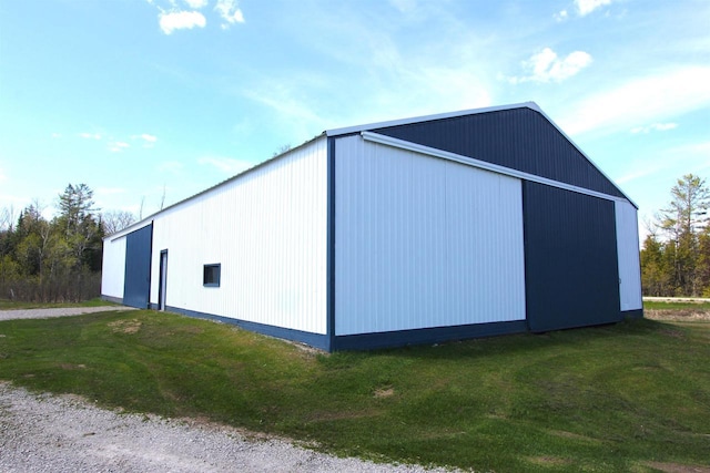 view of outbuilding featuring a yard