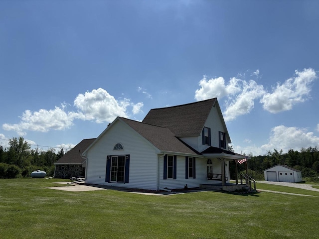 view of property exterior with a lawn, a garage, covered porch, and an outbuilding