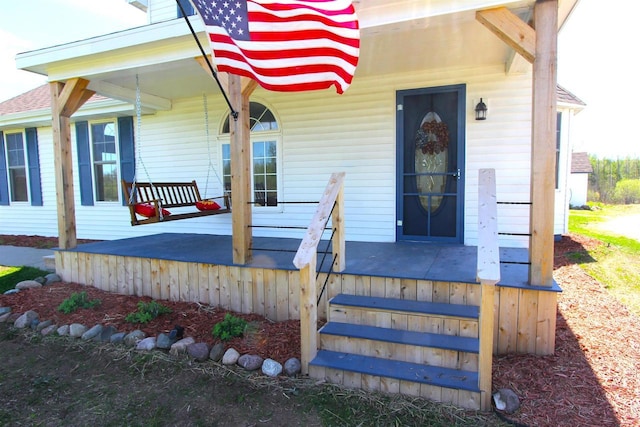 property entrance featuring a porch