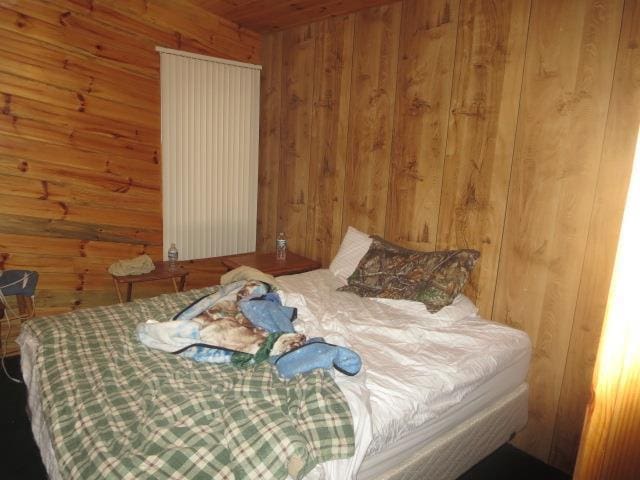 bedroom with wood walls