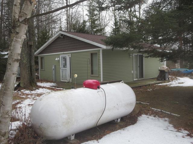 view of snow covered back of property