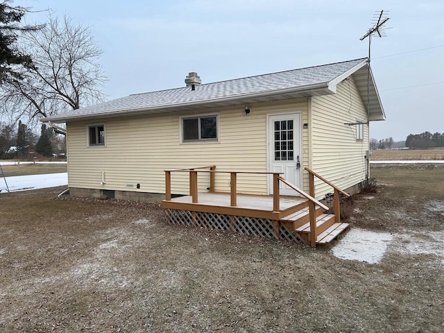 rear view of property featuring a wooden deck