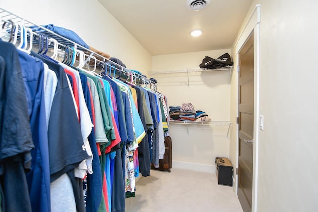 walk in closet with carpet flooring