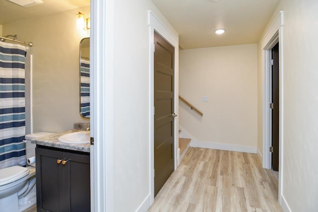 corridor featuring sink and light hardwood / wood-style floors