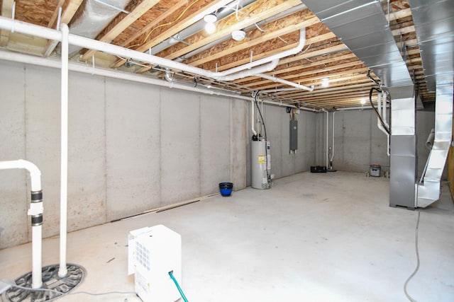 basement featuring heating unit, electric panel, and gas water heater