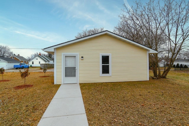 rear view of house featuring a yard