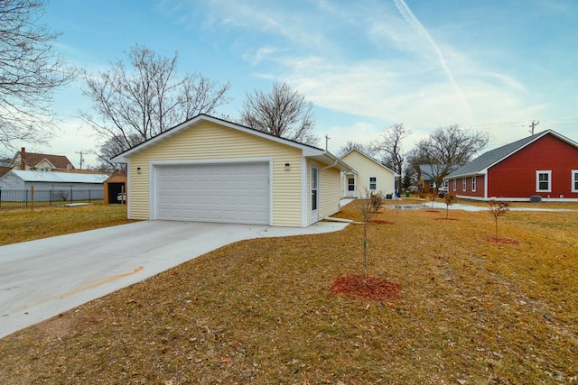 view of side of home featuring a garage and a lawn