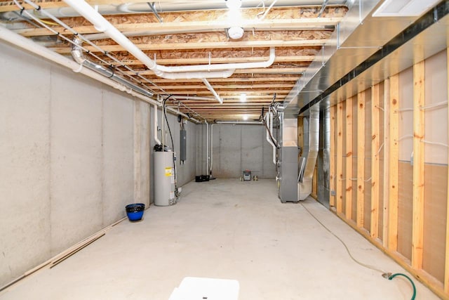 basement with heating unit, water heater, and electric panel