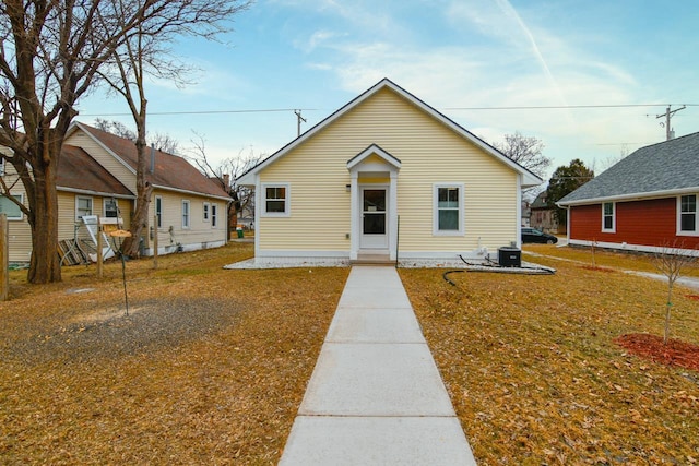 bungalow featuring central AC and a front lawn