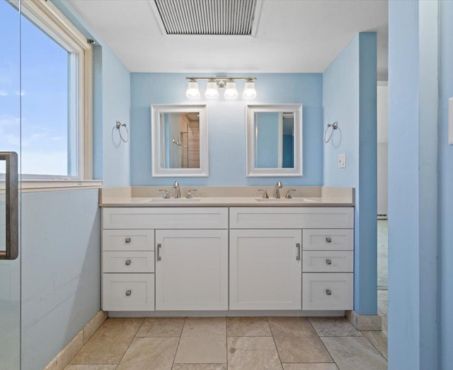 bathroom with plenty of natural light, walk in shower, and vanity