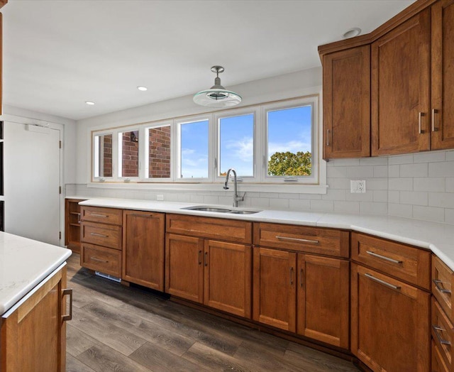 kitchen with backsplash, dark hardwood / wood-style floors, and sink