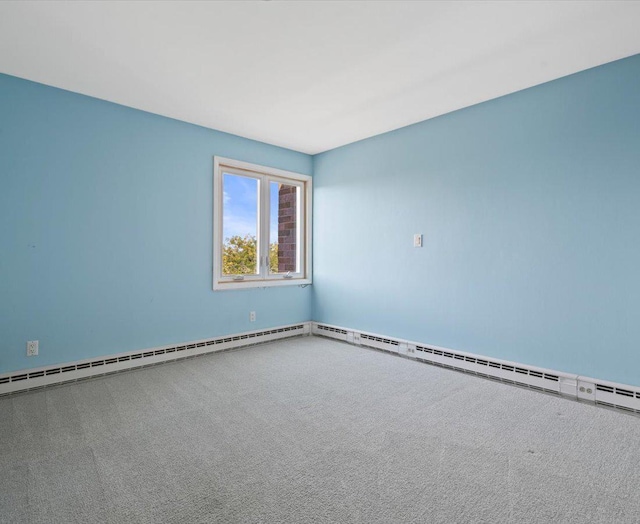 carpeted empty room with baseboard heating