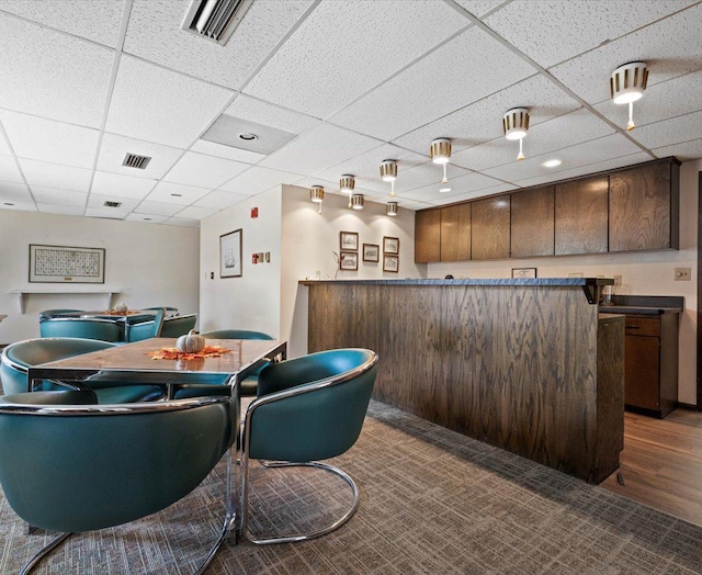 dining space with a paneled ceiling