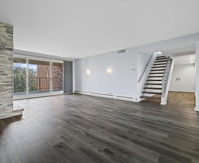 unfurnished living room featuring expansive windows, baseboard heating, and dark wood-type flooring