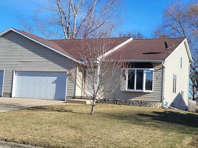 ranch-style house featuring a front yard and a garage