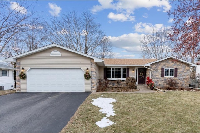 ranch-style house with a garage and a front yard