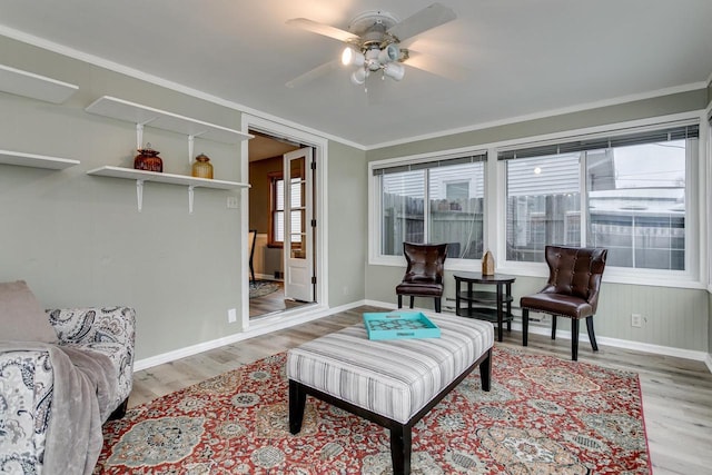 sitting room featuring ceiling fan, light hardwood / wood-style flooring, and ornamental molding