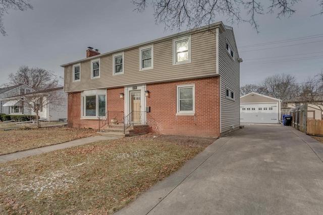 view of front of home with a garage and an outdoor structure