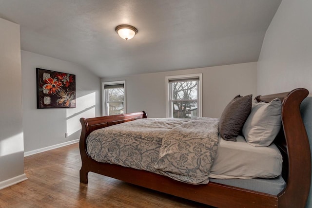 bedroom featuring wood-type flooring and vaulted ceiling