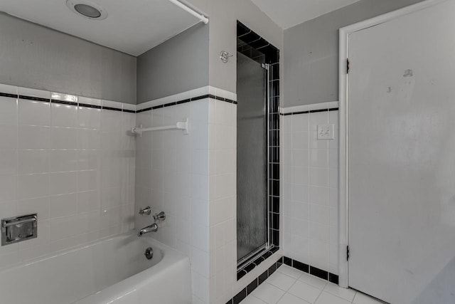 bathroom featuring tile patterned flooring and tile walls