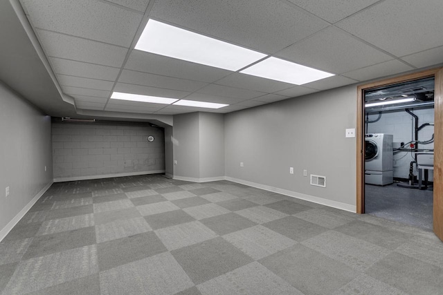 basement featuring a paneled ceiling, washer / clothes dryer, and sink