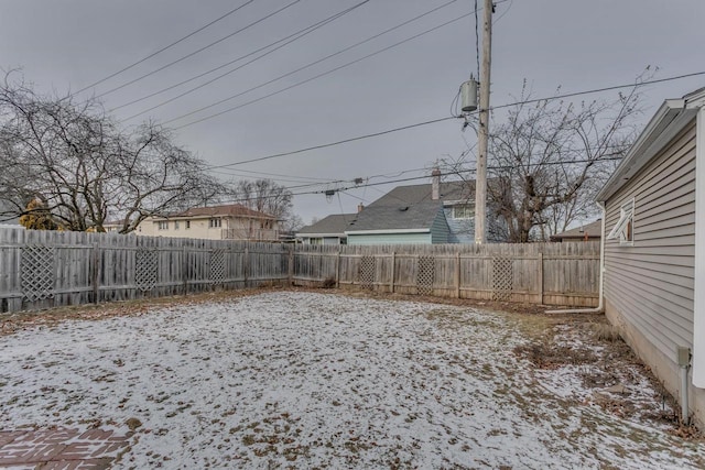 view of yard layered in snow